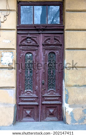 Old wooden door covered with cracks, worn paint. An ideal base for creative design fashion trend in modern development