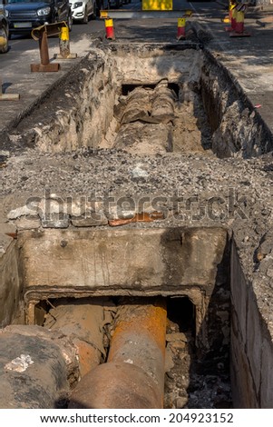 repair roadworks. Trench old rusty pipes and water heating duct disclosed for routine repair and replacement before the winter heating season