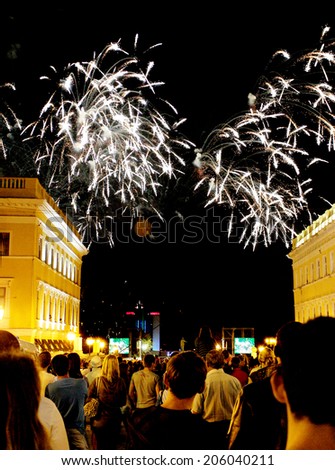 ODESSA, UKRAINE - September 2, 2011: Numerous crowd and residents enjoyed watching the festive fireworks at night city streets September 2, 2011 in Odessa, Ukraine.