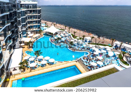 ODESSA, UKRAINE - JULY 20: Tourists on holiday in an expensive hotel Nemo popular with cascading pools and with dolphins and white whales, and dzhakusi bar July 20, 2014 Odessa, Ukraine.