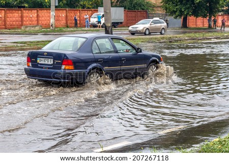 ODESSA, UKRAINE - July 24, 2014: As a result of heavy rainfall disaster flooded streets. Cars fording. Flooding. July 24, 2014 in Odessa, Ukraine