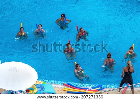 ODESSA, UKRAINE - JULY 20: Tourists on holiday in an expensive hotel Nemo popular with cascading pools and with dolphins and white whales, dzhakusi bar, water aerobics July 20, 2014 Odessa, Ukraine.