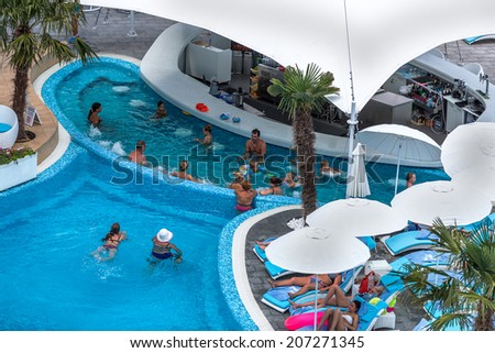 ODESSA, UKRAINE - JULY 20: Tourists on holiday in an expensive hotel Nemo popular with cascading pools and with dolphins and white whales, dzhakusi bar, water aerobics July 20, 2014 Odessa, Ukraine.