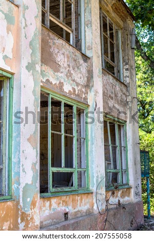 Outside the abandoned and broken homes, broken windows, damaged walls