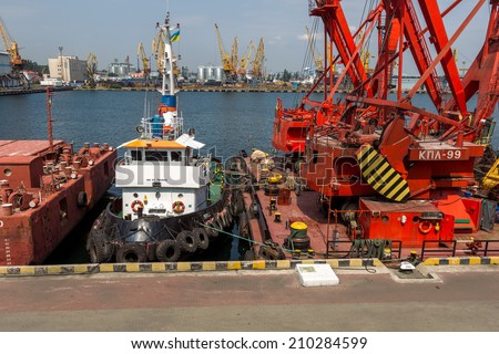 ODESSA, UKRAINE - JULY 23: large floating marine crane for loading the goods in the dry bulk cargo ships in the harbor of Odessa sea port. Mechanisms and buckets, July 23, 2014 Odessa, Ukraine
