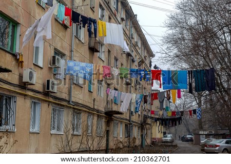 ODESSA, UKRAINE - JANUARY 18: The courtyard of old city have been washed clean clothes and bed linen hanging out to dry between old houses and trees on tight rope, 18 January 2013, Odessa, Ukraine