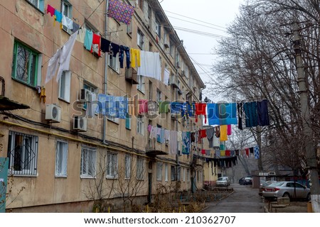 ODESSA, UKRAINE - JANUARY 18: The courtyard of old city have been washed clean clothes and bed linen hanging out to dry between old houses and trees on tight rope, 18 January 2013, Odessa, Ukraine