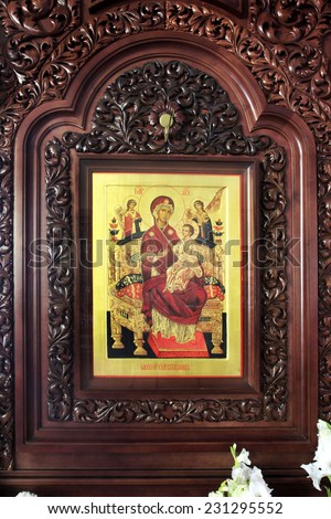 Orthodox wooden icon of the Mother of God with baby Jesus in a beautiful carved wooden salary