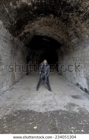 Odessa, Ukraine - November 22: Stylized clothing and hairstyle punk rock band fan party in the tunnel in front of the basement rock concert circuit and metal ornaments 22, 2014 in Odessa, Ukraine