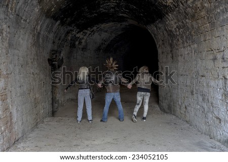 Odessa, Ukraine - November 22: Stylized clothing and hairstyle punk rock band fan party in the tunnel in front of the basement rock concert circuit and metal ornaments 22, 2014 in Odessa, Ukraine