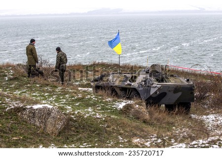 Odessa, Ukraine - December 6, 2014: Ukrainian armed forces on the field checkpoint with combat military equipment BMP, Ukrainian flag, mountain, December 6, 2014 in Odessa, Ukraine.