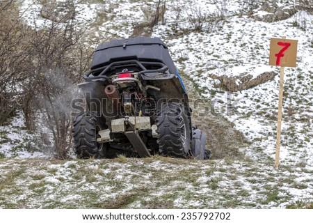 Odessa, Ukraine - December 6, 2014: Off-road vehicle on a motocross track on the road passes in winter mountains, December 6, 2014 in Odessa, Ukraine.