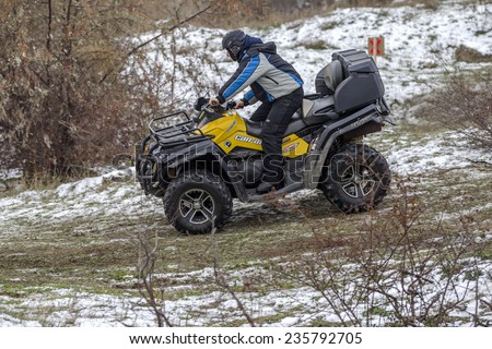 Odessa, Ukraine - December 6, 2014: Off-road vehicle on a motocross track on the road passes in winter mountains, December 6, 2014 in Odessa, Ukraine.