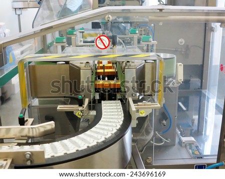 ODESSA, UKRAINE - JULY 11: The modern factory production of pharmaceutical technologies. Pharmaceutical industry. Conveyor production line of tablets, July 11, 2013 in Odessa, Ukraine