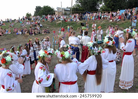 ODESSA, UKRAINE - August 24, 2014: Ukrainian people celebrating girl National Day holiday Midsummer on the river in bright robes embroidered Ukrainian cross