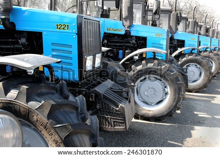 ODESSA, UKRAINE - 31 March 2011: The new agricultural tractors of various models stand in a row at the exhibition site in readiness for the start of spring sowing of agricultural