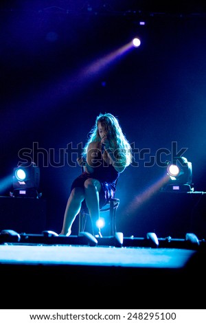 ODESSA, UKRAINE - 20 June 2014: in a nightclub at a concert during the creative light and music show. stage smoke on a club party. Singer Tina Karol Ukraine and her jazz band