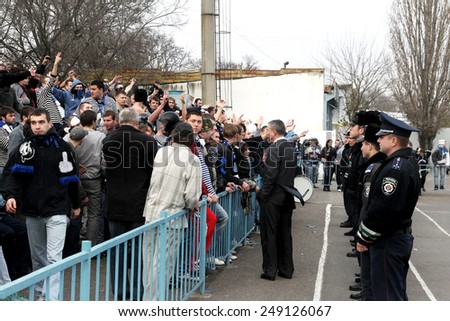 Odessa, Ukraine - November 14, 2010: Ultras emotional football fans during the game for his club Chernomorets rioted with police, broken rostrum, fights, fireworks on the playing field