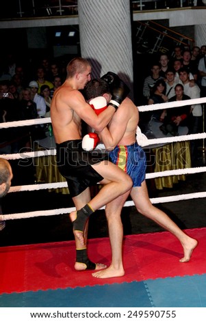 Odessa, Ukraine - October 14, 2010: Fight Club. Fighting without rules. Mixed martial arts fighters compete in the cell, resulting in punches and kicks. The dramatic moment of the battle.