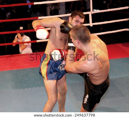 Odessa, Ukraine - October 14, 2010: Fight Club. Fighting without rules. Mixed martial arts fighters compete in the cell, resulting in punches and kicks. The dramatic moment of the battle.