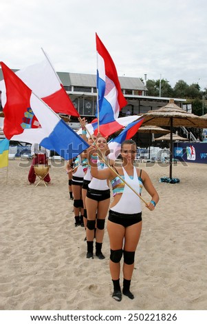Odessa, Ukraine - September 4, 2010: Bright dynamic performance of women\'s support group sports team on the sandy shores of Black Sea. Cheerleaders in Aktion. Bright beautiful young girl in sportswear