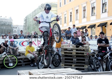 Odessa, Ukraine - July 28, 2007: Young male jumping freestyle and doing acrobatic tricks at a bike trial. BMX, MTB