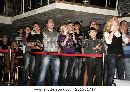 Odessa, Ukraine - October 14, 2010: Fight Club. Spectators watch the emotional struggle of athletes during the fight without rules. The dramatic moment of the battle.