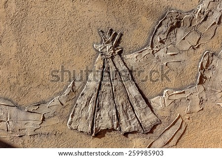 stone facade fresco wall decoration. Bas-relief image cowboy Indians and desert landscapes of America, Texas, with mountains and cactus