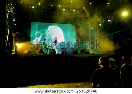 Odessa, Ukraine - August 25, 2011: Crowd Published on outdoor rock concert at night, during creative light and music show fashionable jazz orchestra. The audience raised their hands in delight and fun
