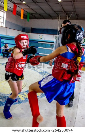 Odessa, Ukraine March 27, 2015: Ukrainian Cup on boxing among children. Muay Thai boxing. In the ring fighting girls boxers. Women\'s boxing.