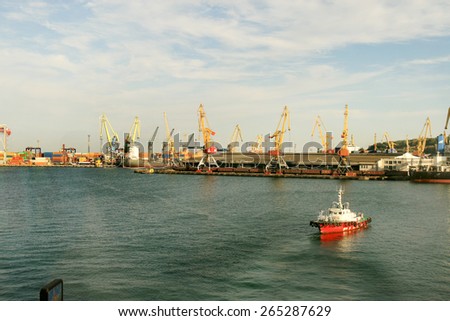Odessa, Ukraine -5 December 2008: Sea container terminal. Marine cranes loads more shipping containers on cargo ship. The storage area containers. Sea transportation of cargo. Fashion Vanilla tinting