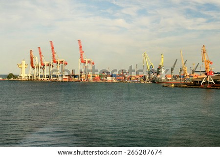 Odessa, Ukraine -5 December 2008: Sea container terminal. Marine cranes loads more shipping containers on cargo ship. The storage area containers. Sea transportation of cargo. Fashion Vanilla tinting