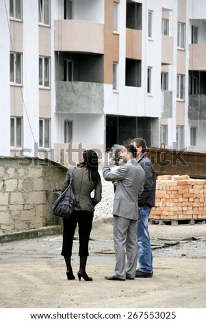 Odessa, Ukraine - November 3, 2008: Construction site of a high-rise apartment building. Delivery of construction. Finishing work. Buyers, tenants visiting the home. Apartments for sale. facade work