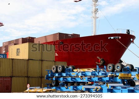 Odessa, Ukraine -5 December 2008: Sea container terminal. Marine cranes loads more shipping containers on a cargo ship. The storage area containers. Sea transportation of cargo