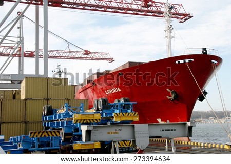 Odessa, Ukraine -5 December 2008: Sea container terminal. Marine cranes loads more shipping containers on a cargo ship. The storage area containers. Sea transportation of cargo