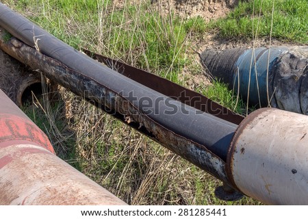 Repair of old rusty big water pipes with holes of corrosion of the metal. Replacement of corroded metal pipes to plastic water pipes. Selective focus.