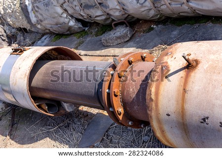 Repair of old rusty big water pipes with holes of corrosion of the metal. Replacement of corroded metal pipes to plastic water pipes. Selective focus.