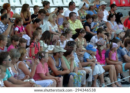 Odessa, Ukraine - July 10, 2013: Ecstatic happy spectators of all ages delightedly watching vivid picture dresirovannyh dolphins. Show at the dolphinarium