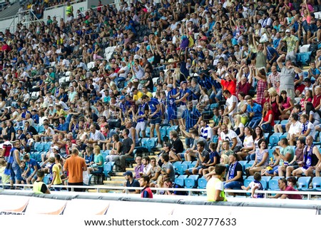 ODESSA, UKRAINE - August 2, 2015: Football fans and spectators in the stands of the stadium emotionally support their team during the game FC Dynamo Kyiv - Chernomorets Odessa. Major League.