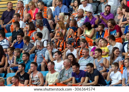 ODESSA, UKRAINE - 14 August, 2015: Football fans and spectators in  stands of the stadium emotionally support their team during  game of FC Shakhtar (Donetsk) - Dnipro (Dnipropetrovsk).  Ukrainian Cup