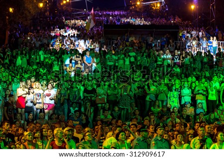 Odessa, Ukraine - September 2, 2015: The audience at concert during creative light and music show fashionable jazz orchestra. Night scene, audience emotionally watching, standing outside on stairs