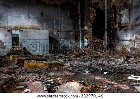 Landscape with the ruins of old industrial factory buildings. The interior of an abandoned factory with rubble plunder and waste. Collapse of economy.  Selective focus as background for design trash