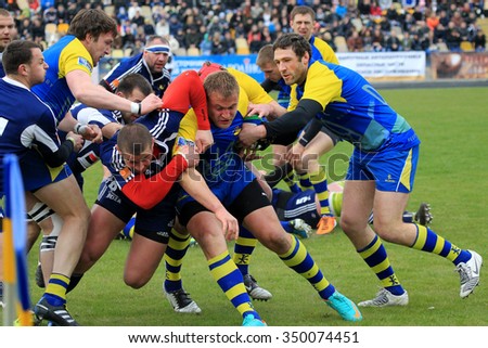 Odessa, Ukraine -7 April 2013: International European Cup rugby. Team of Moldova and Ukraine. Players jostle and fight fiercely for possession Ball. The tense battle of match