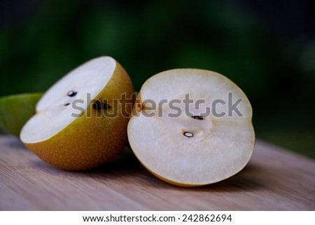 The cut pear on a wooden table