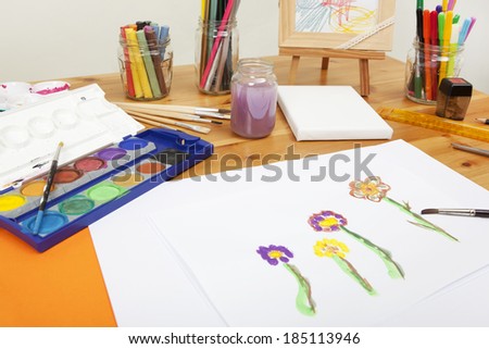different things lying on a table to try arts and crafts, painting with water colors