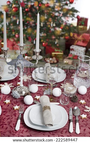 Festive table with christmas tree in the background