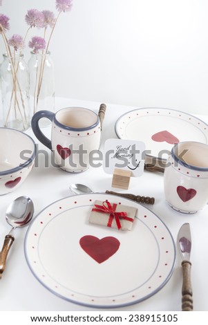 good morning as text on a sign for breakfast on dishes with hearts