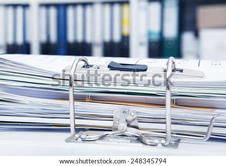 Desk in an office with a full file folder