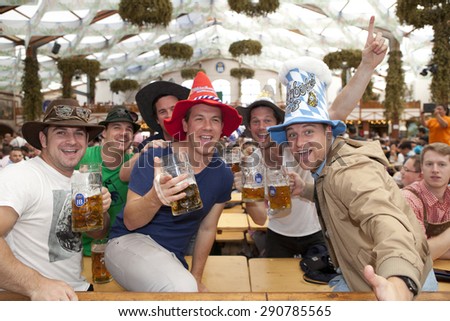 Oktoberfest, Munich, Germany, 25.09.2013, Visitors sit in the tent at the Oktoberfest and beer in a beer mug