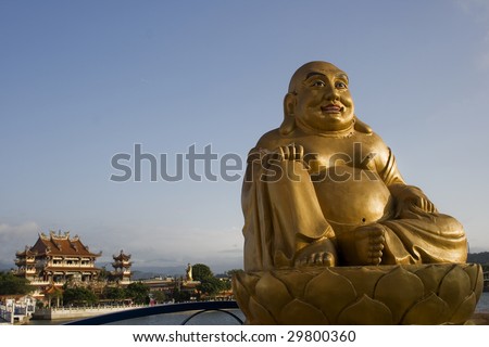 This is a statue of the laughing Buddha, outside a Chinese Temple.  The laughing Buddha is a common in Chinese Buddhism